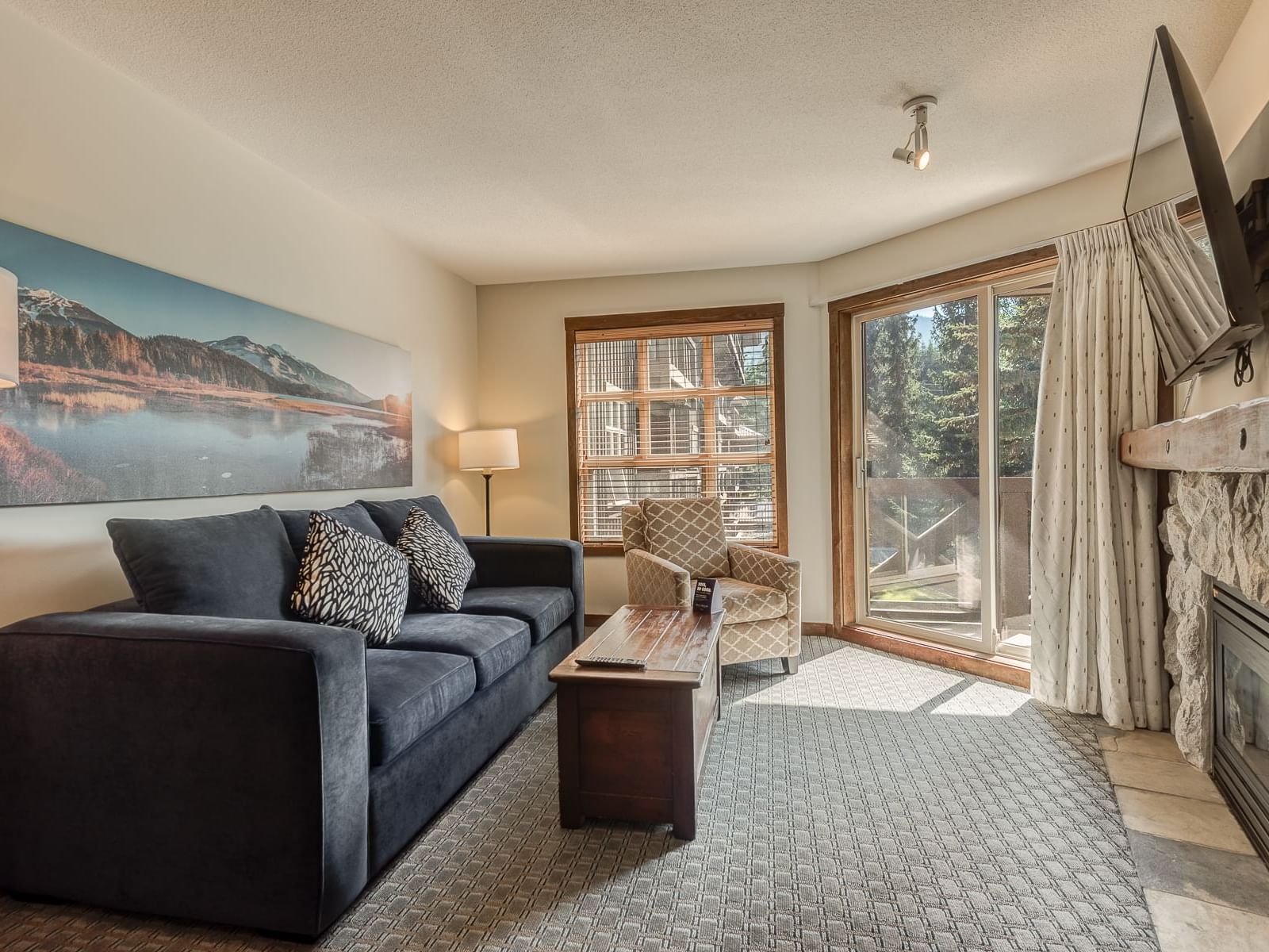 TV lounge area with carpeted floors in 1 Bedroom Slopeside at Blackcomb Springs Suites