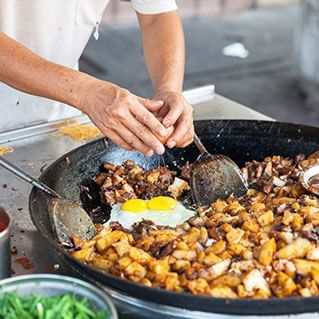 A man is cooking local delights in penang