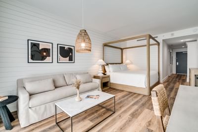 Bedroom with a canopy bed & a sofa at Boulan South Beach
