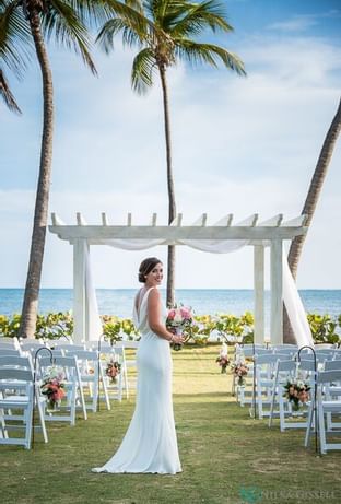 A bride standing on the isle at Copamarina Weddings