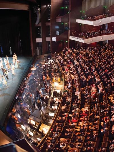 Theater with audience watches a performance at Queensland Performing Arts Centre near Sofitel Brisbane Central