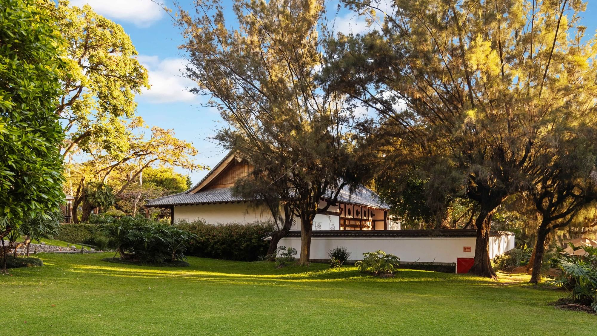 Grand Fiesta Americana Sumiya Cuernavaca building with lush greenery and trees.