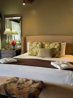 Elegant Erakor Residence bedroom at Warwick Le Lagon Efate with tropical decor and wooden floors.