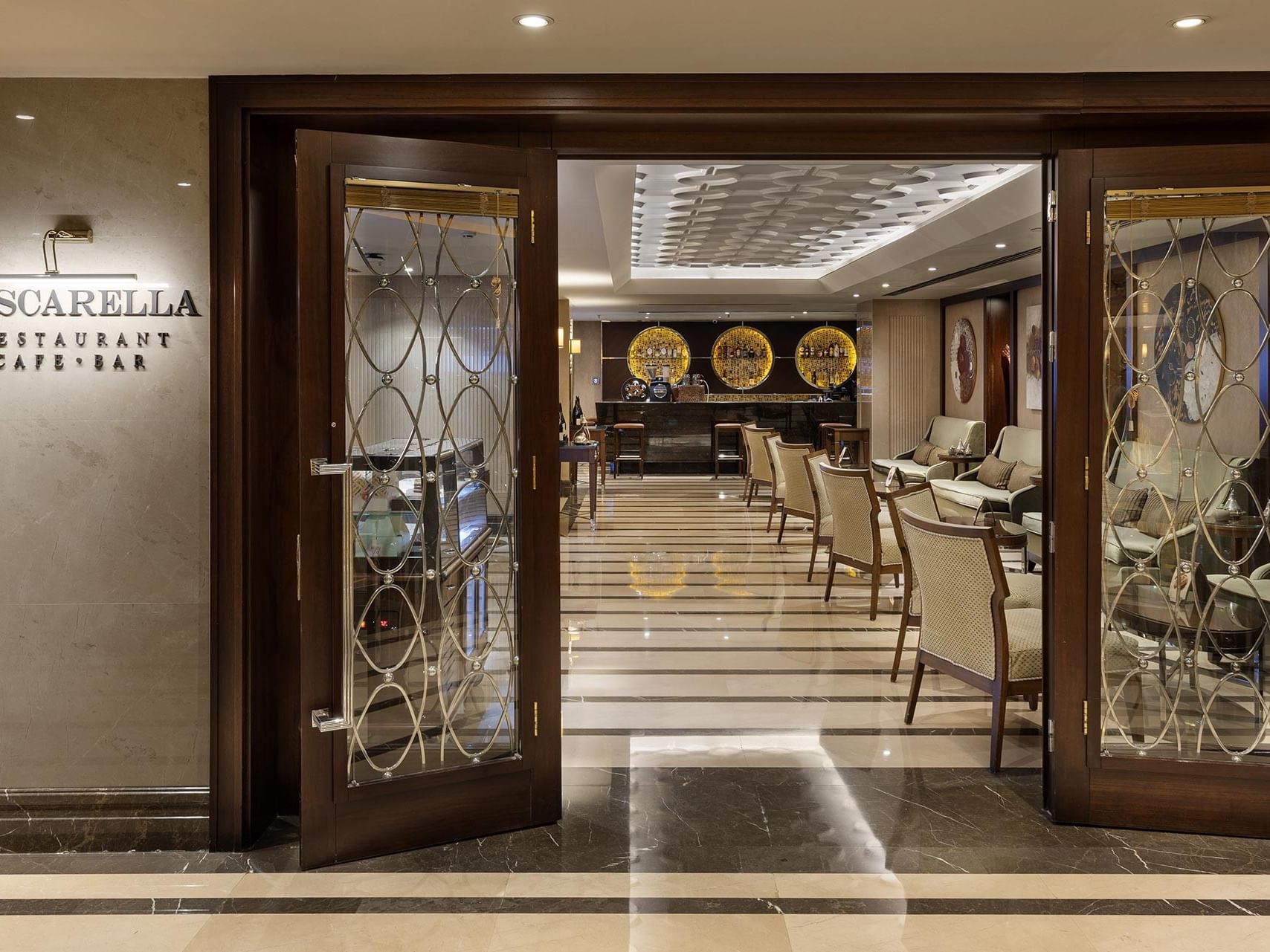 Entrance to Pascarella Restaurant Cafe Bar with glass doors and interior view of dining area.