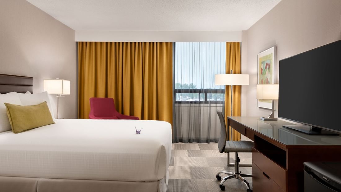 Bed facing TV in modern hotel room
