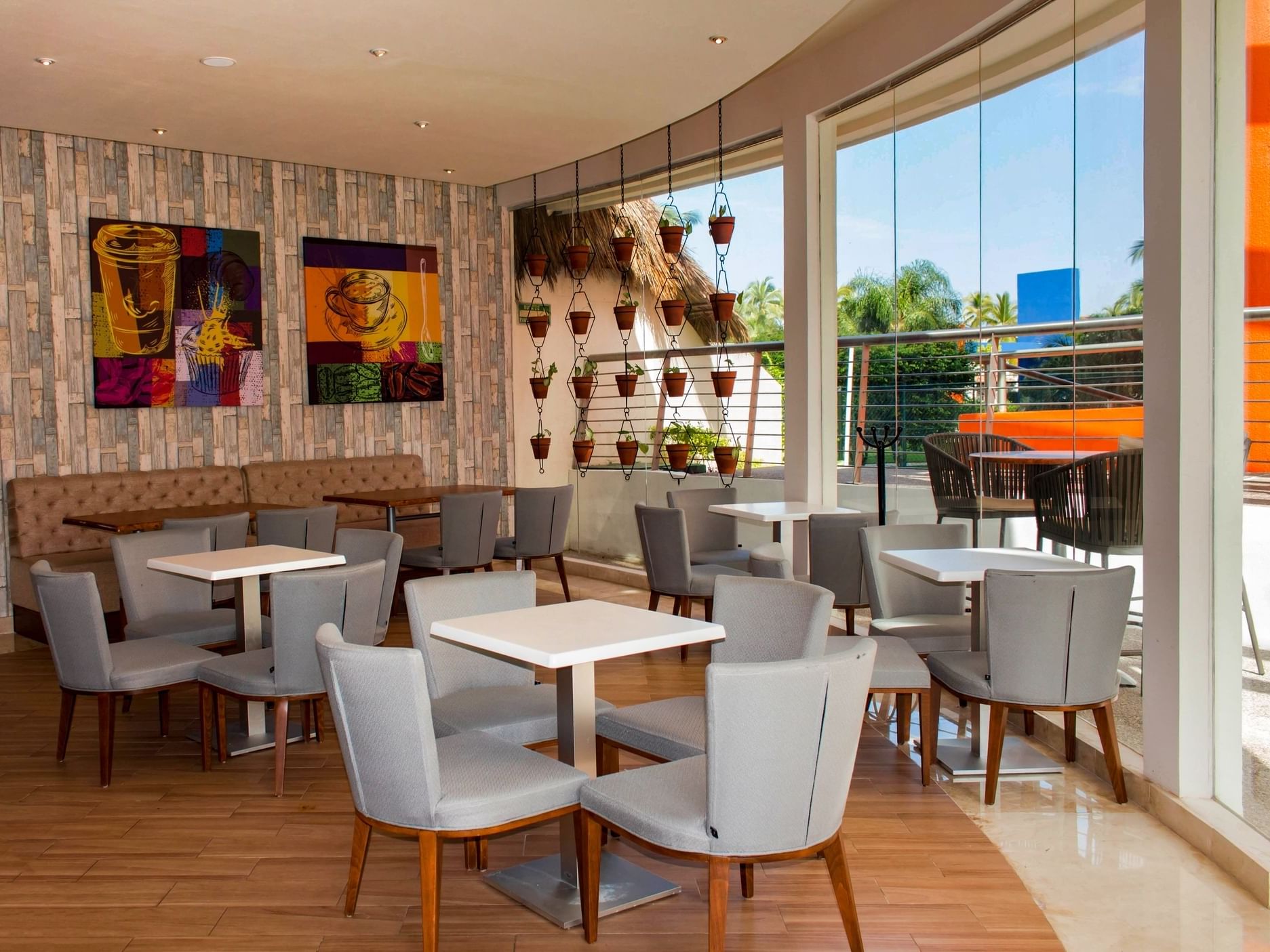 Al Fresko with a salad bar, sleek decor, and outdoor view, featuring tables and chairs for dining at Sunset Plaza Resort