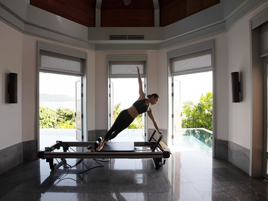 A female guest doing yoga at Amatara Wellness Resort Phuket