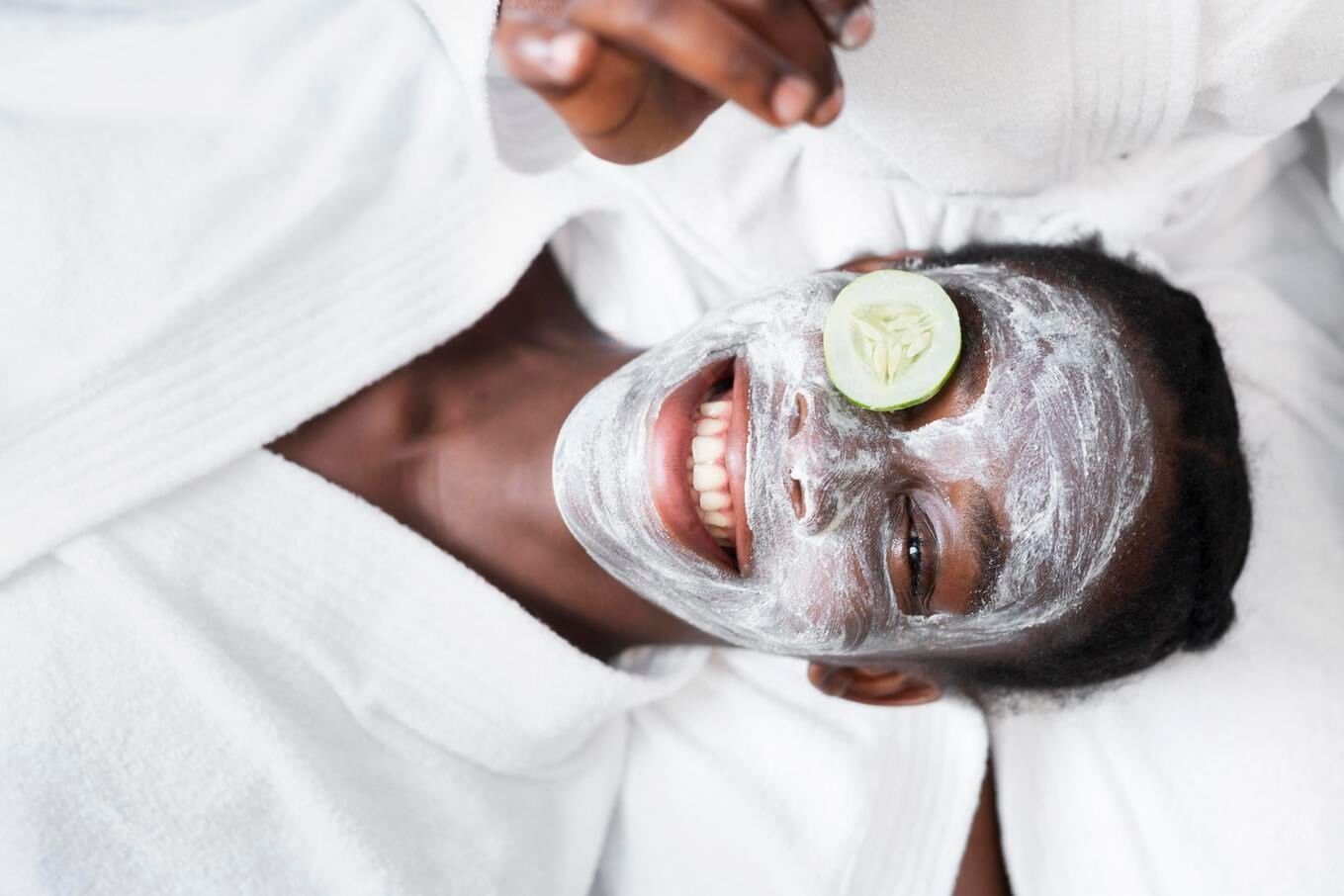 Woman with a facial mask and cucumber slice at Tamarind Tree Hotel