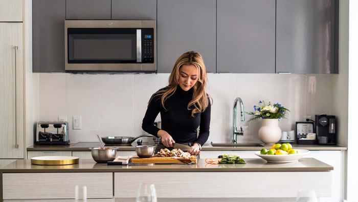 A lady preparing a meal in a room at ReStays Ottawa