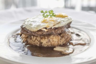 Close-up of Loco Moco served in Ilima Cafe at Waikiki Resort Hotel by Sono
