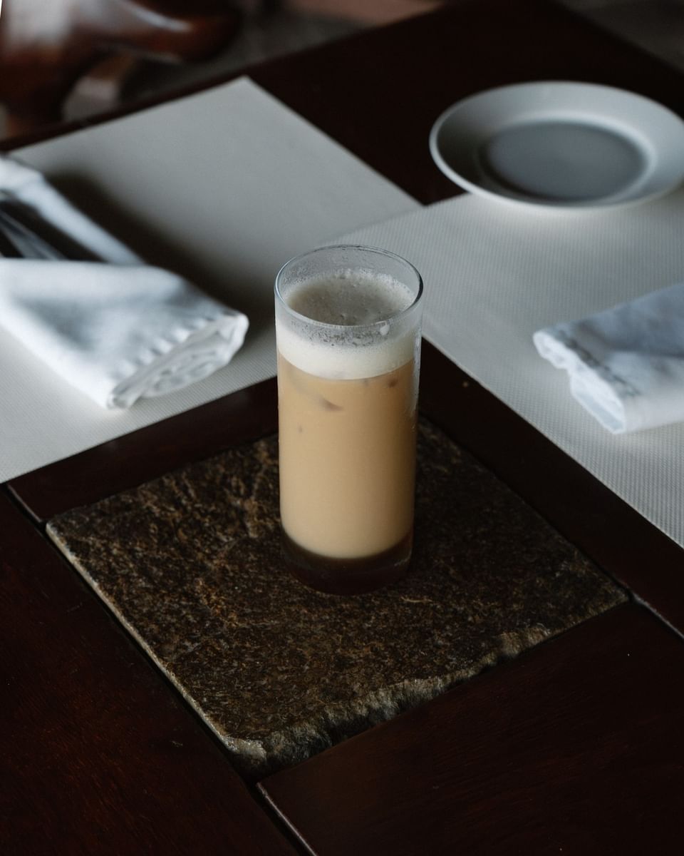 Refreshing iced coffee latte on a stone coaster at Morgan's Rock, one of the best restaurants in San Juan del Sur