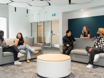 University students connect in light and modern shared lounge area.
