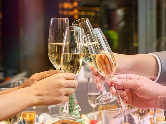 A diverse group of individuals joyfully toasting with champagne glasses in celebration.