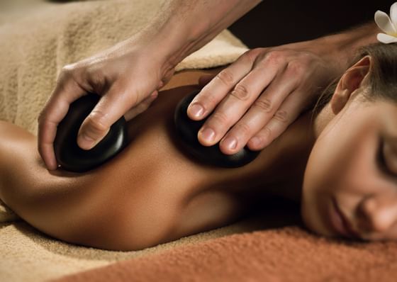 Close-up of hot stone therapy in the spa at Honor's Haven