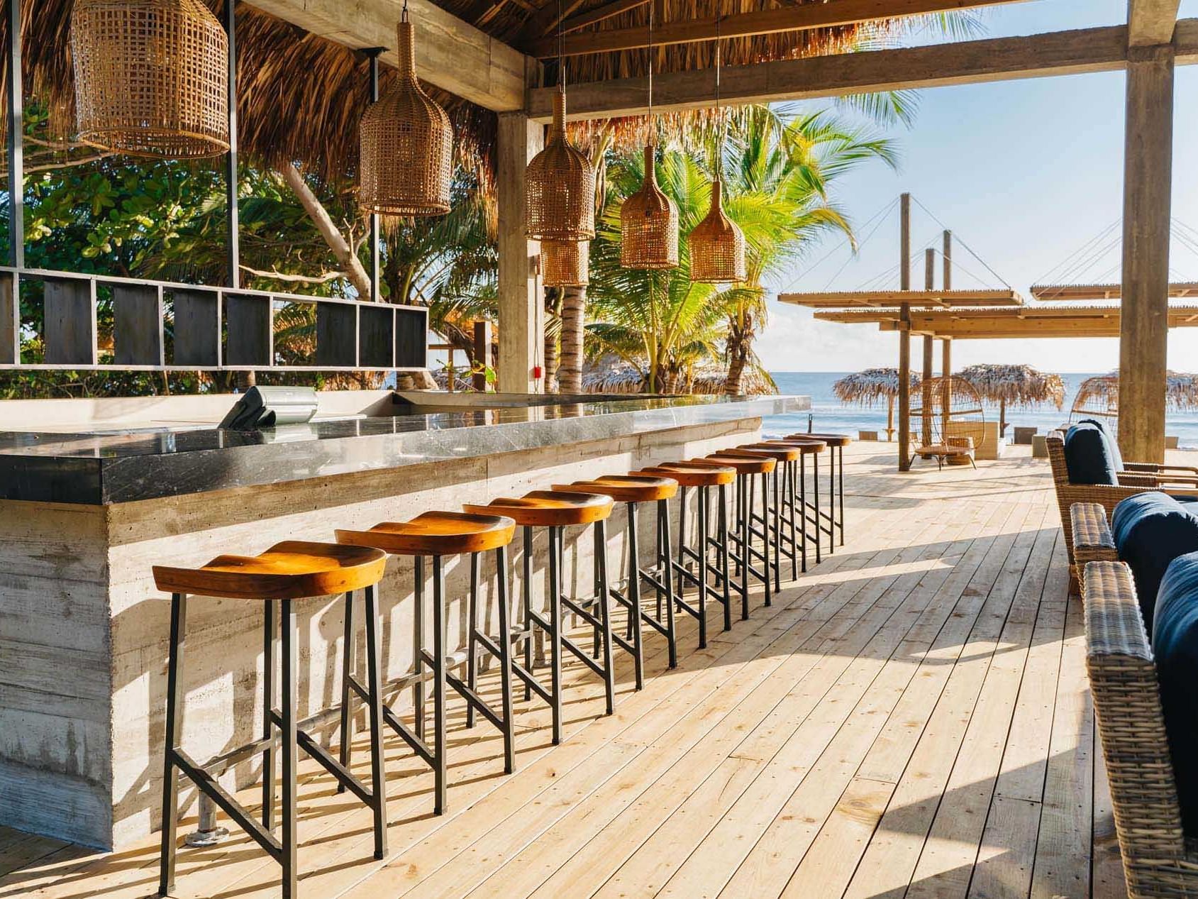Open air bar & lounge area in Duna Beach Club at Indura Resort