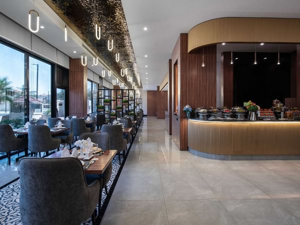 Elegant interior of a dining area with buffet counter in a restaurant at Warwick Hotel Al Jubail