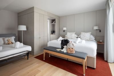 Bed and furniture in Mews Family Room at The Goodenough Hotel