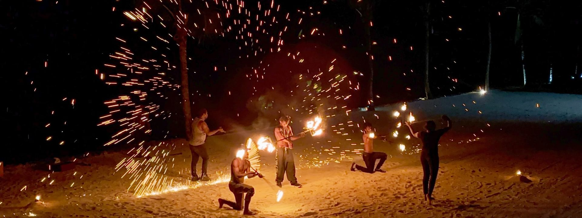 Performers doing a fire show on the beach at night at Warwick Le Lagon - Vanuatu, Efate