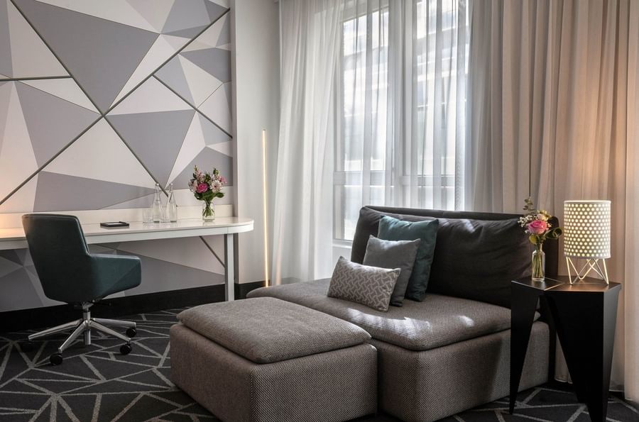 Premium Loft Suite with a sofa and work desk near the window at Warwick Le Crystal Montreal