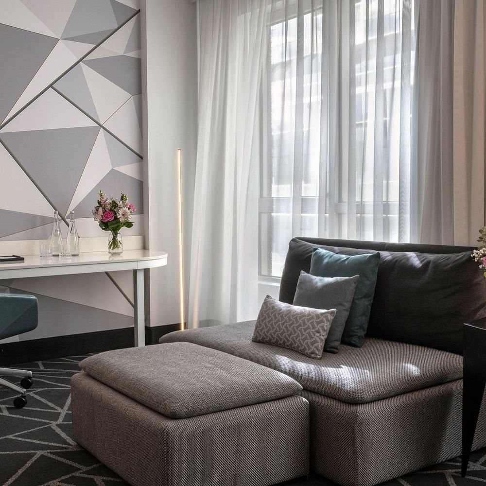 Premium Loft Suite with a sofa and work desk near the window at Warwick Le Crystal Montreal