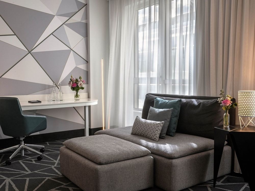 Modern living room with sofa and desk in Premium Loft Suite at Warwick Le Crystal Montreal