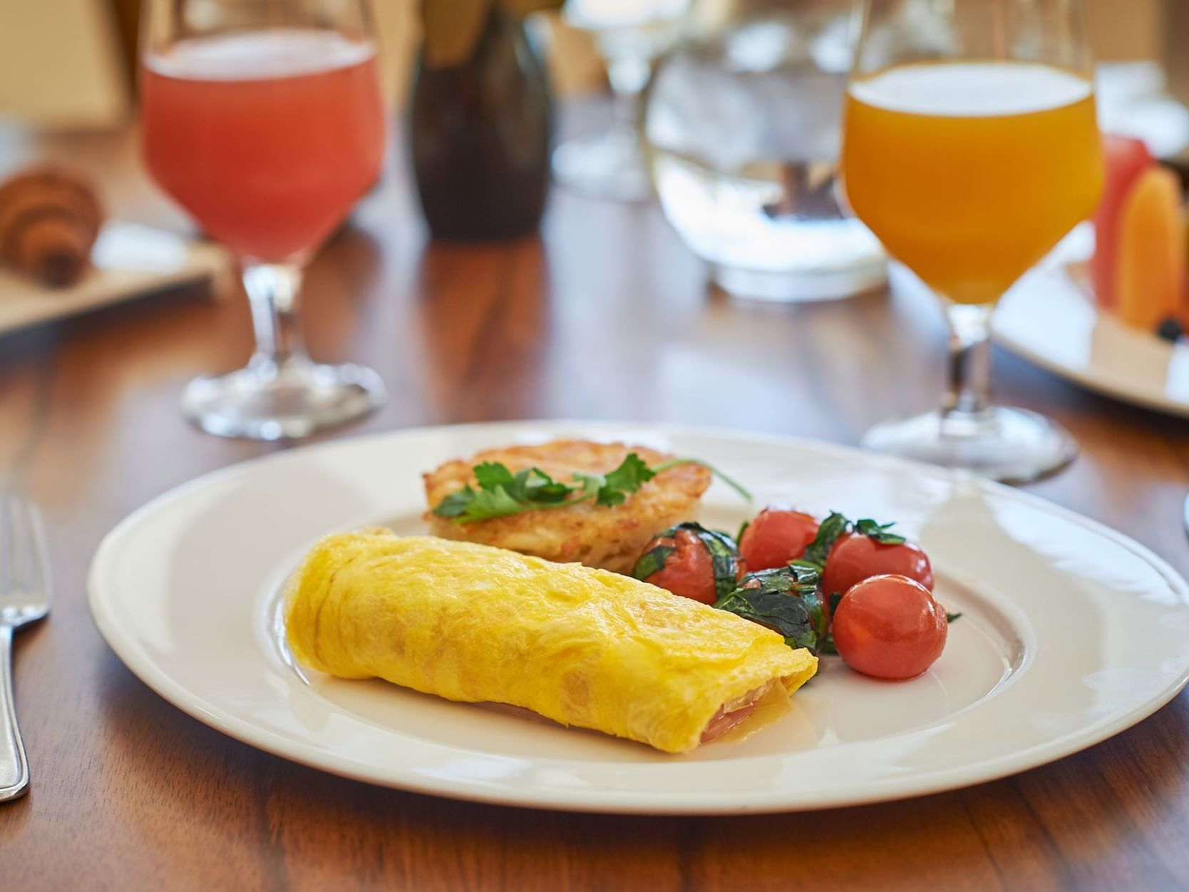 Close-up of omelets served with tomatoes and juices at Gamma Hotels