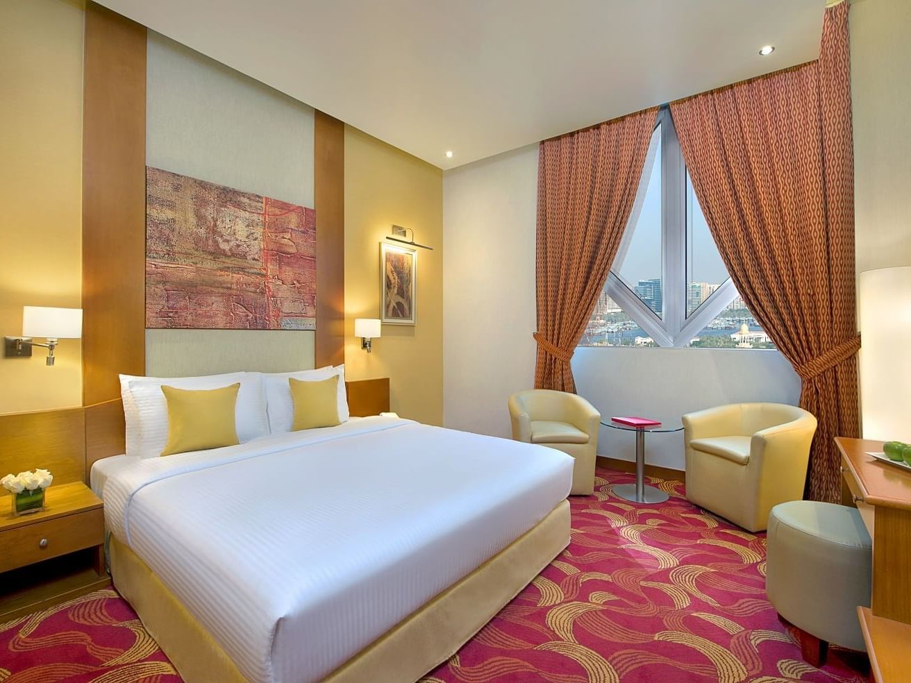 Cozy bed & lounge area in Premium Room at City Seasons Hotels