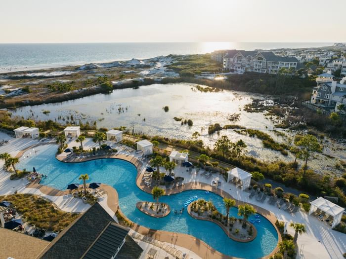 Sunset aerial view of the Watersound Beach Club pool and beach in South Walton, Florida