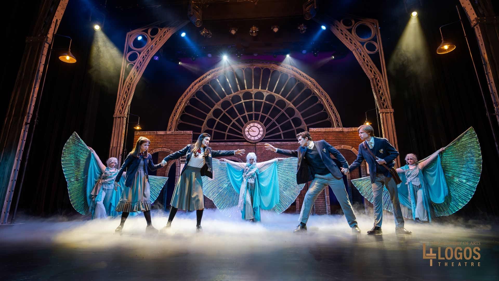 Actors perform on the Hillside Theatre & Events Center stage with a clock tower and winged costumes at Branson Hillside Hotel