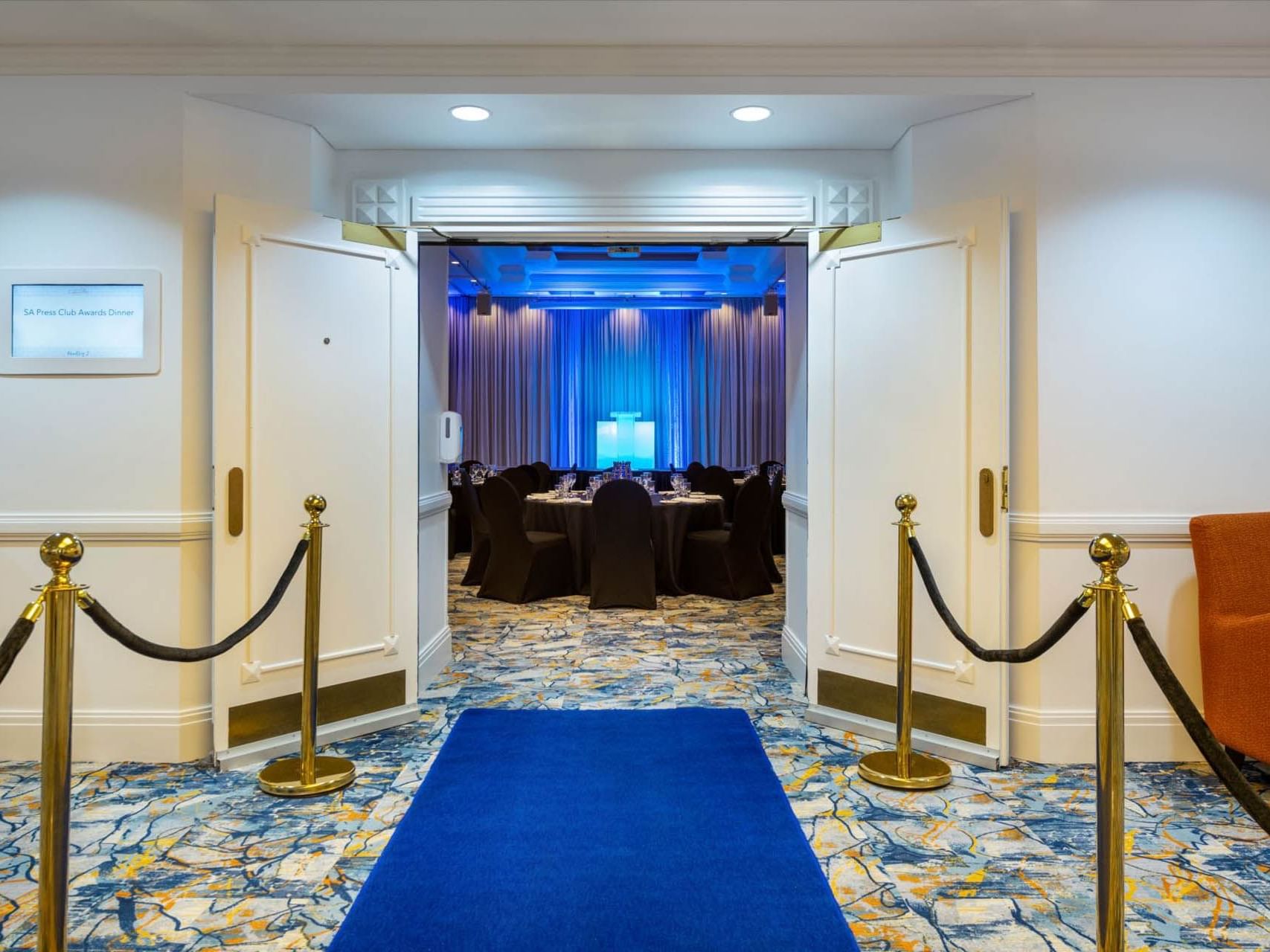Entrance door to the illuminated Ballroom with carpeted floors at Grand Chancellor Adelaide