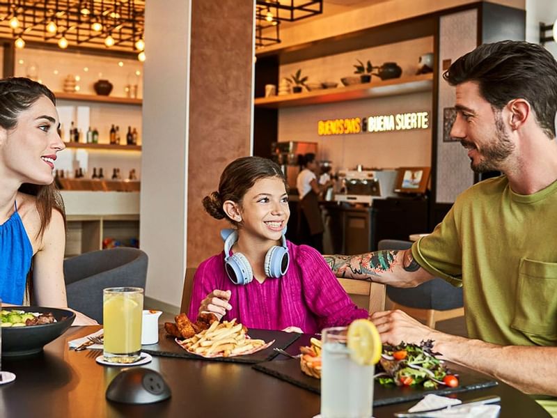 Family enjoying meals in a Restaurant at IOH Freestyle Hotels