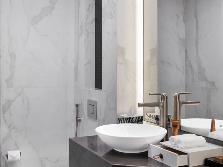 Bathroom vanity with a large mirror in A-List Suite at Paramount Hotel Midtown