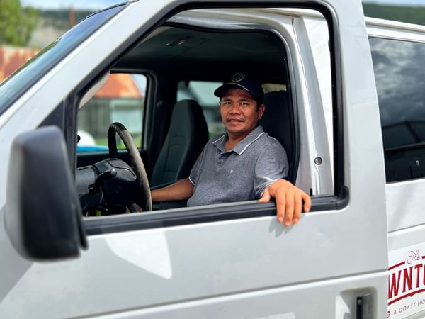 Airport shuttle bus driver in Dawson city near ElDorado, a Coast Hotel