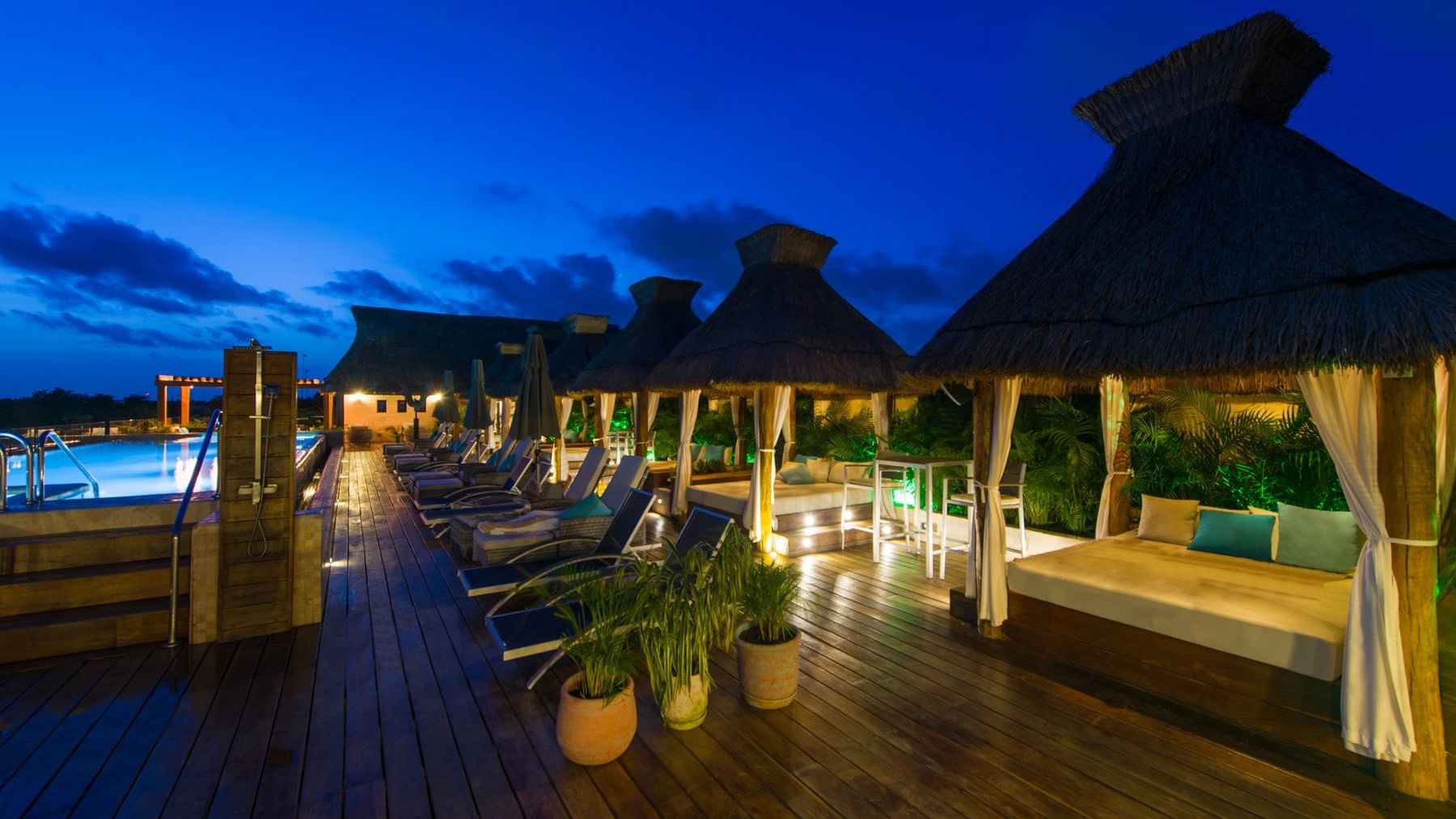 Outdoor pool with cabanas at Naay Tulum Curamoria Collection