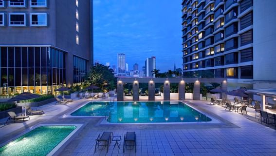 Outdoor swimming pool in Carlton Hotel Singapore at night