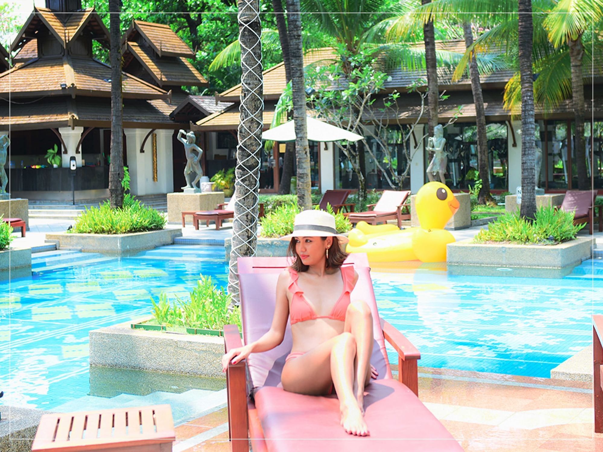 A girl posing on a sunbed at Chatrium Hotel Royal Lake Yangon