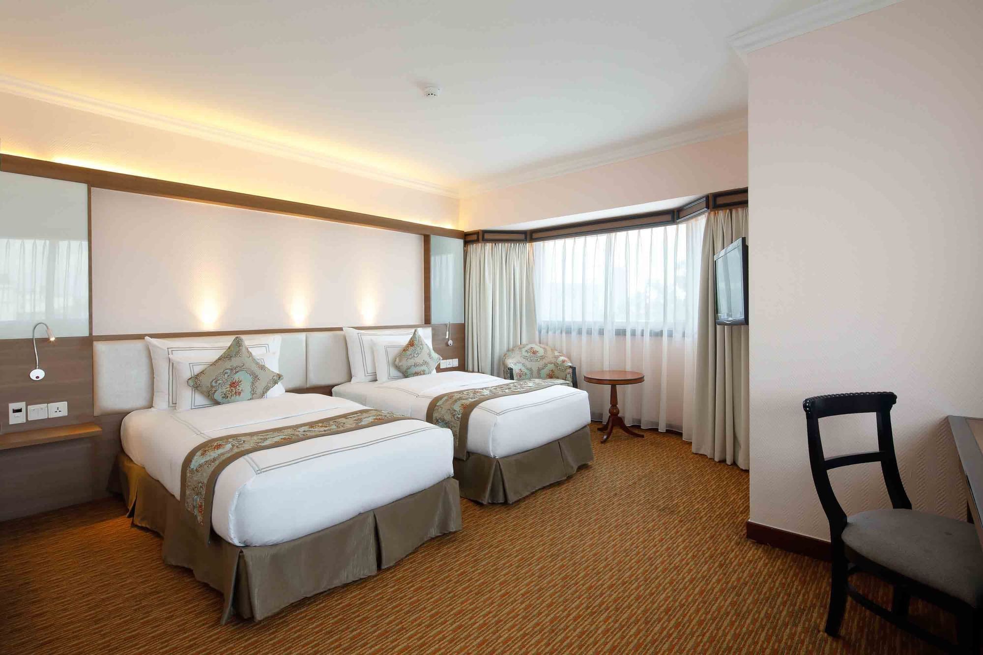 Beds placed by the window in Premiere Club City View Twin at Sunway Hotel Hanoi