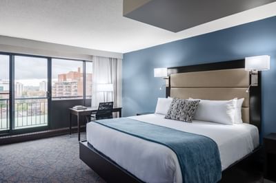room with bed, desk and sliding glass door