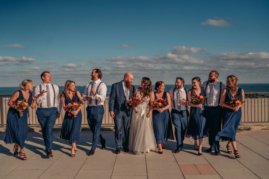 Bride, Groom, groomsman & bridesmaids posing near Ocean Place