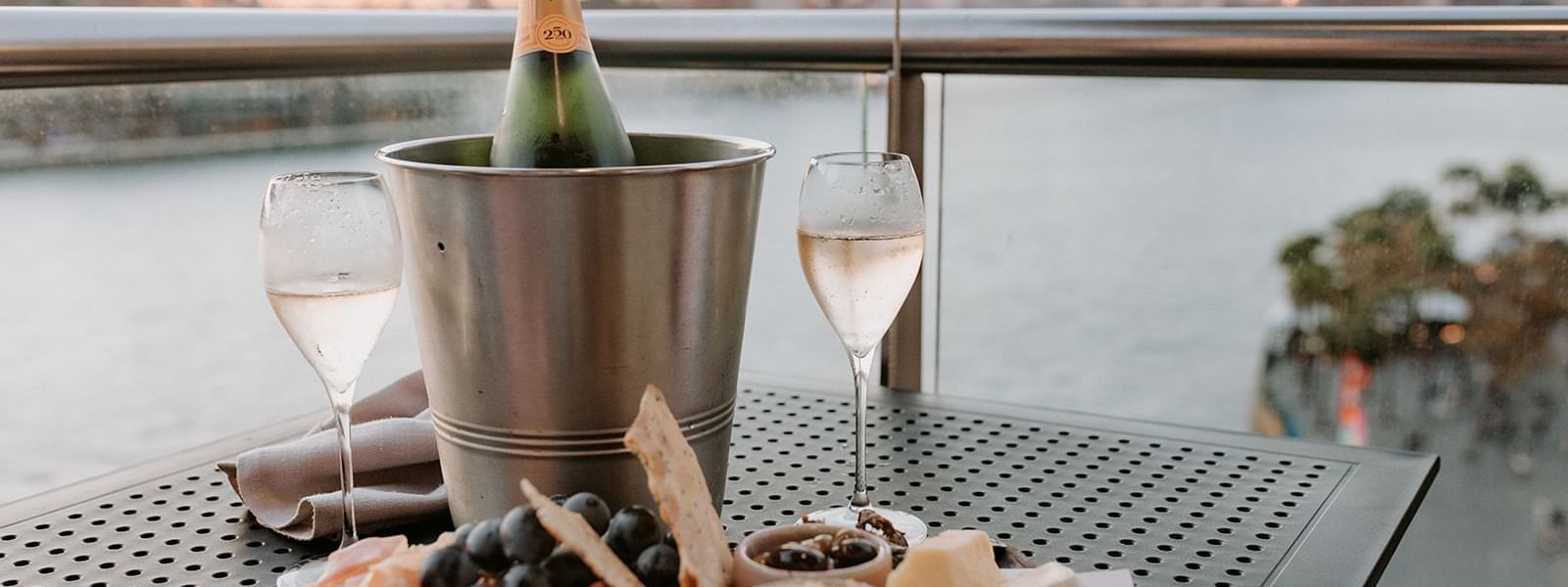 Charcuterie platter served with champagne on ice overlooking the Sydney Harbour Bridge at Pullman Quay Grand Sydney