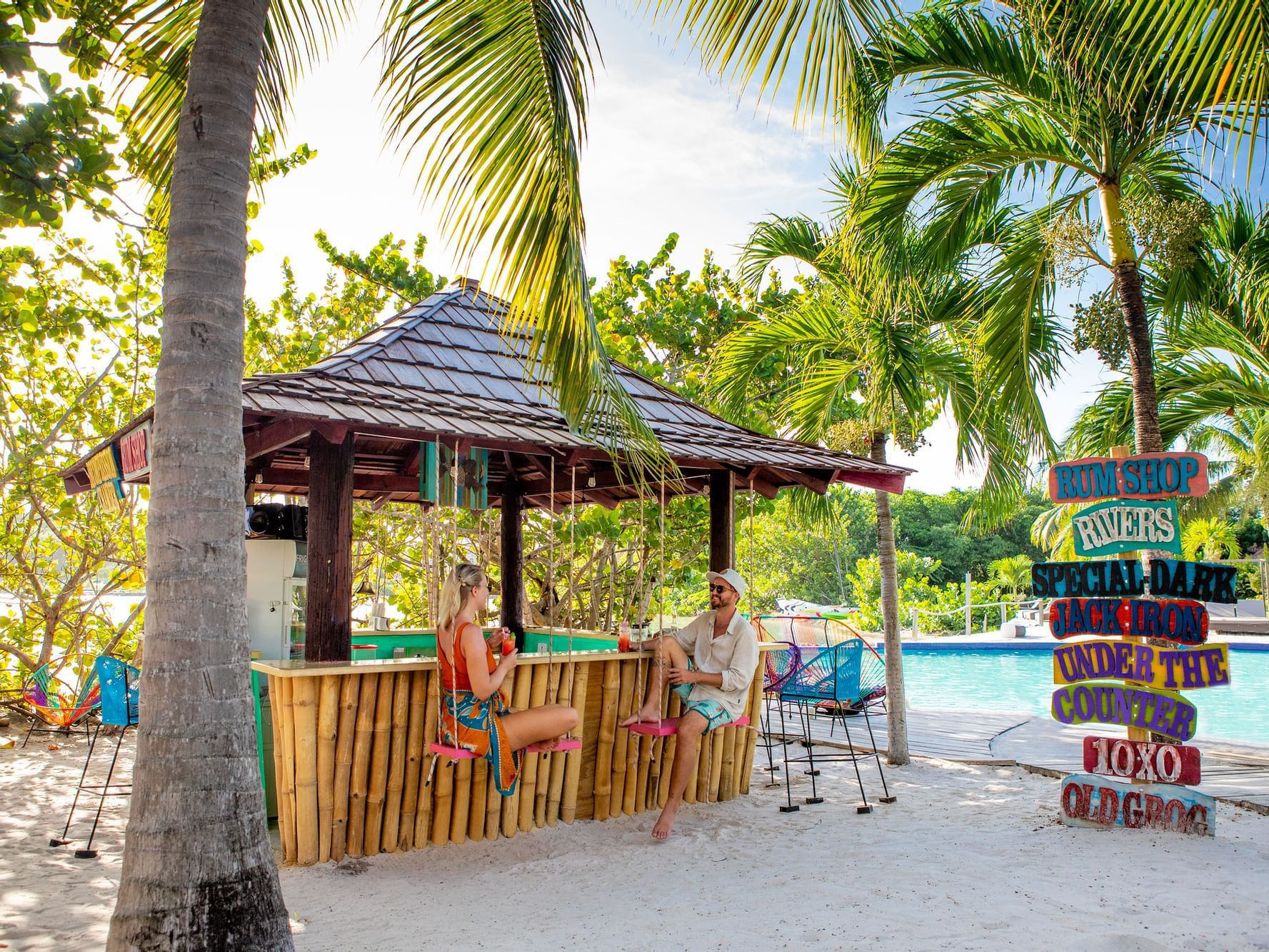 Couple in The Rum Shop Bar by the pool at True Blue Bay Resort