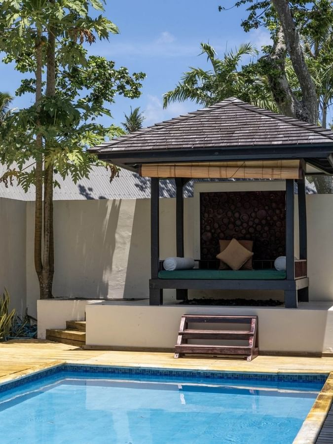 Private outdoor swimming pool with a wooden deck and a cozy garden in Pacific Pool Villa at warwick le lagon-vanuatu 