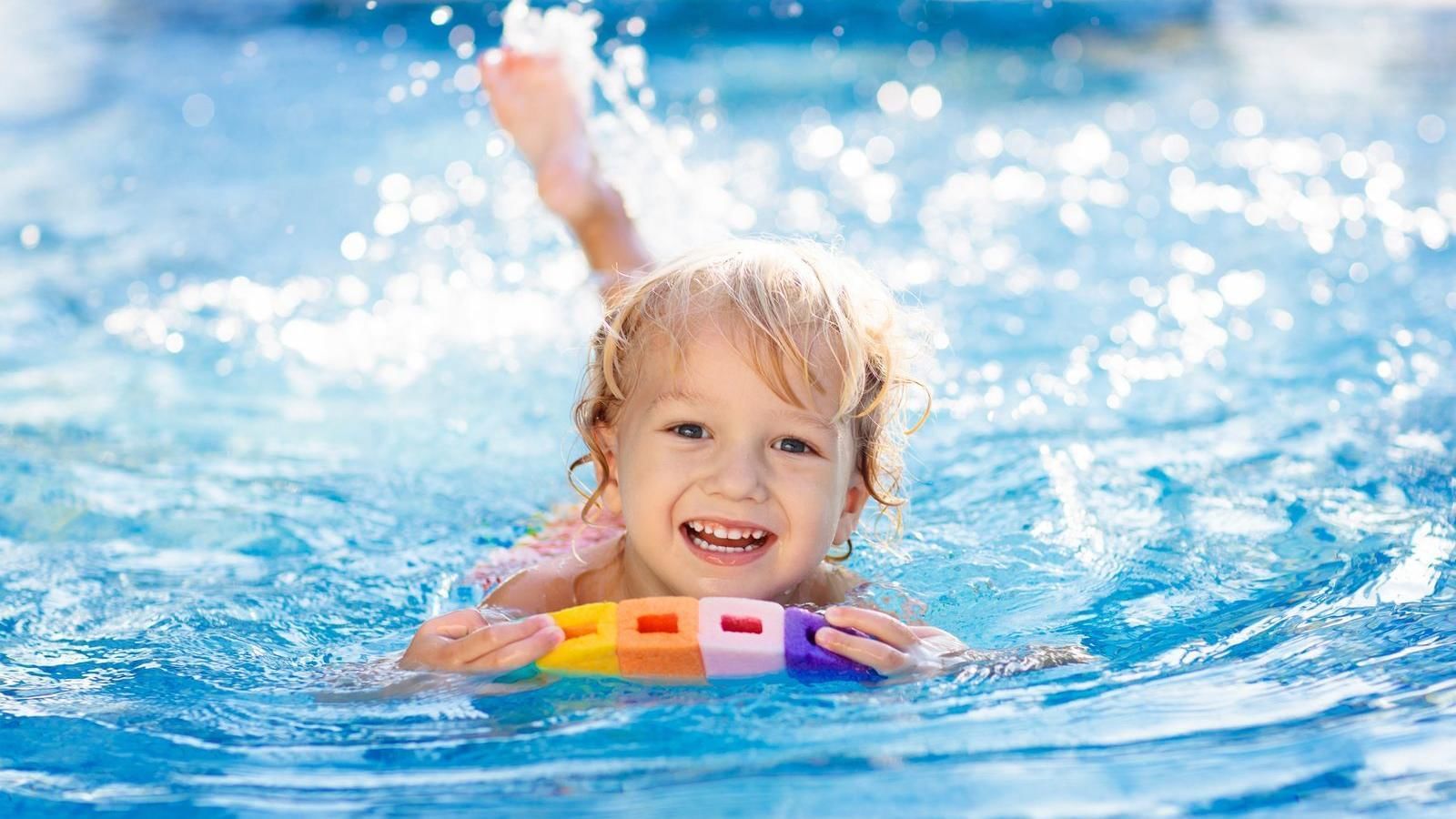 Portrait of kid swims in a pool at Grand FA Puebla Angelópolis