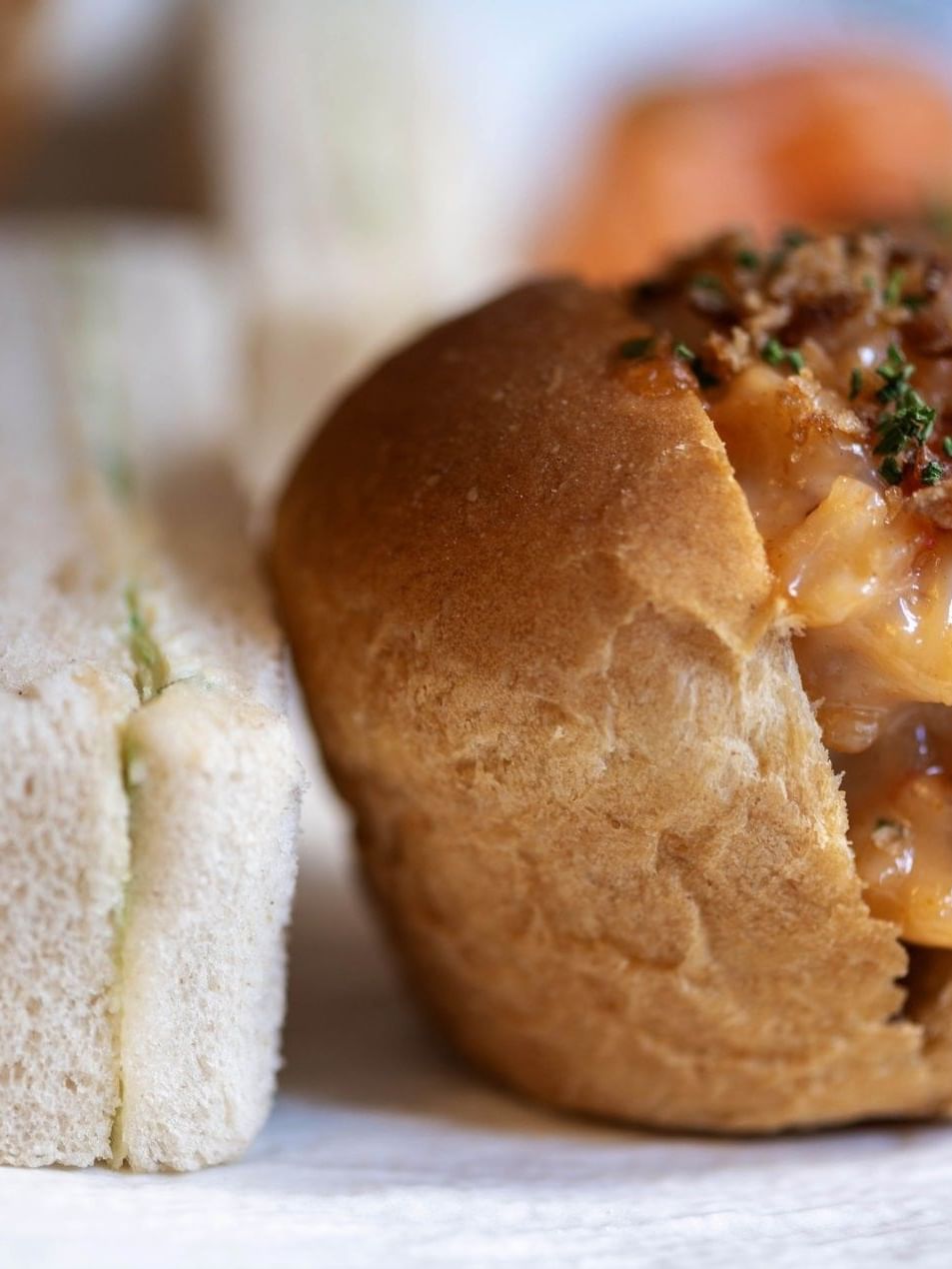 A dish featuring a bread bowl filled with creamy soup next to a sandwich at The Capital Hotel, London.
