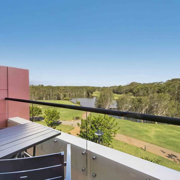 Deluxe Golf View Room Balcony view with outdoor furniture overlooking a golf course at Mercure Kooindah Waters