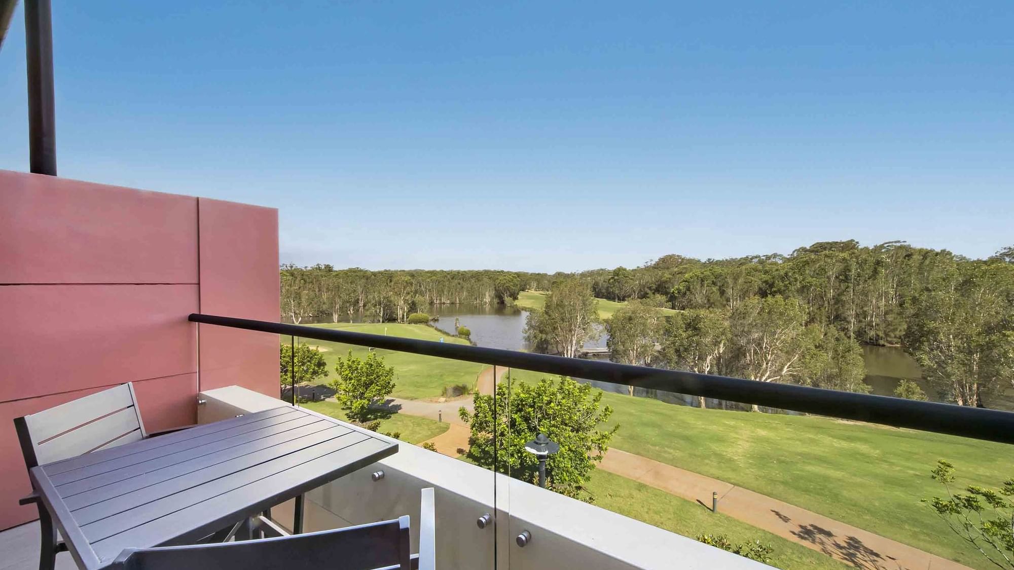 Deluxe Golf View Room Balcony view with outdoor furniture overlooking a golf course at Mercure Kooindah Waters