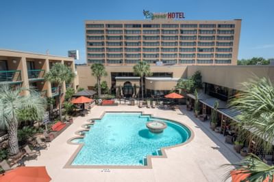 Exterior view of the facade & pool at MCM Elegante Beaumont