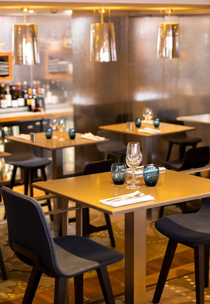 2X2 dining table set-up in a restaurant at Oceania Hotels