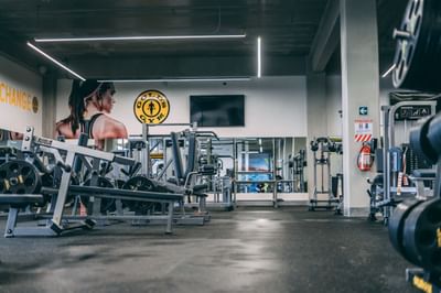 A fitness center with well-equipped machines and weights at Irazu Hotel