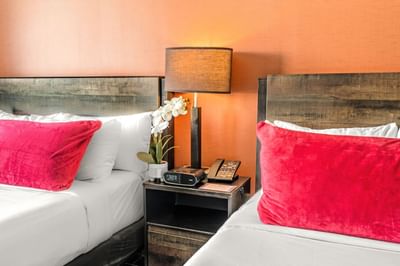 Double beds with a nightstand in Deluxe Double with Balcony at Fairwind Hotel Miami